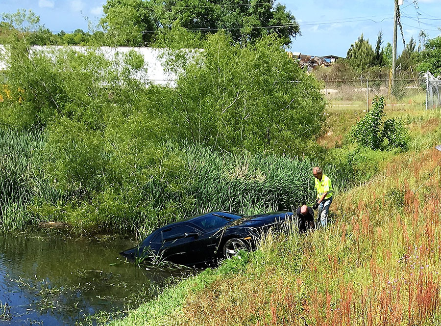 Car in a county holding pond