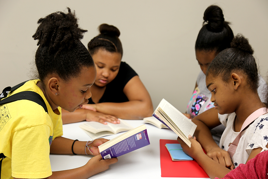 Youth read at the Brownsville Community Center during a summer camp program