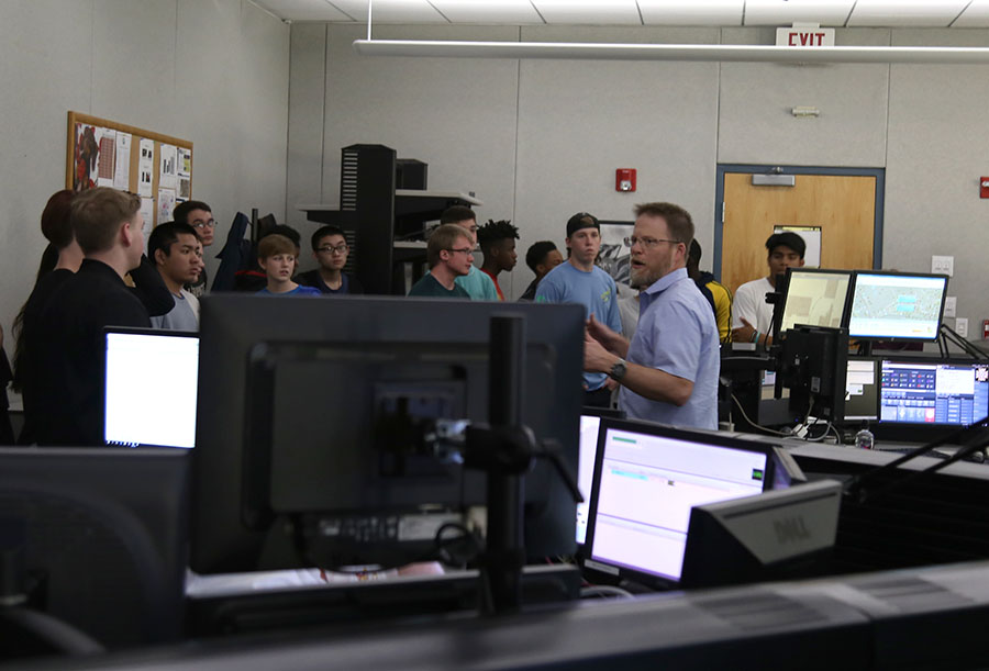 Emergency communications manager Andrew Hamilton gives a tour to students