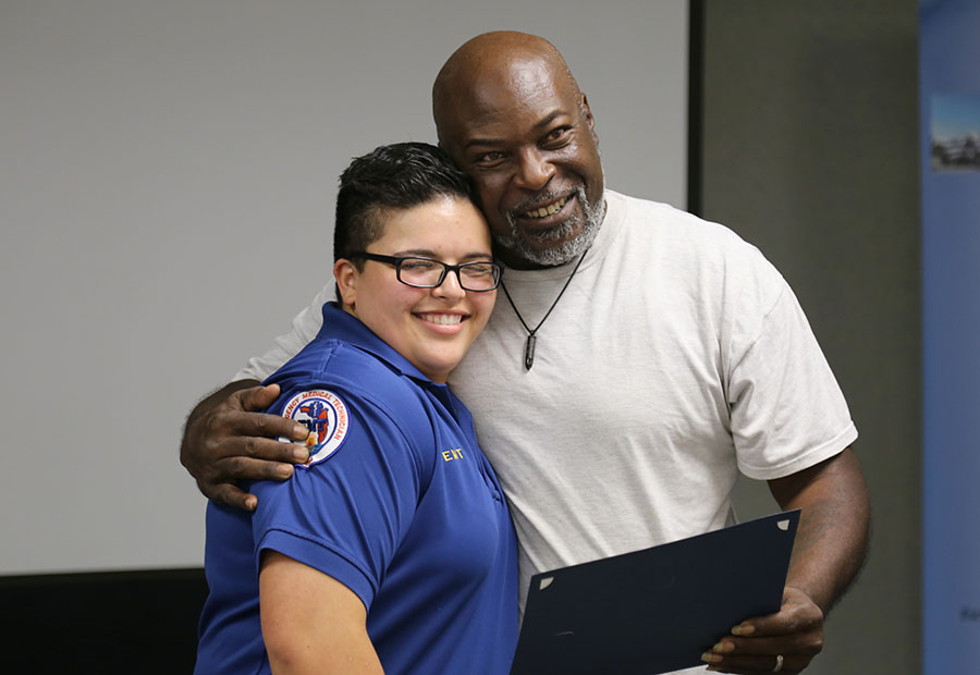 A cardiac arrest survivor is recognized by EMS at a ceremony in May