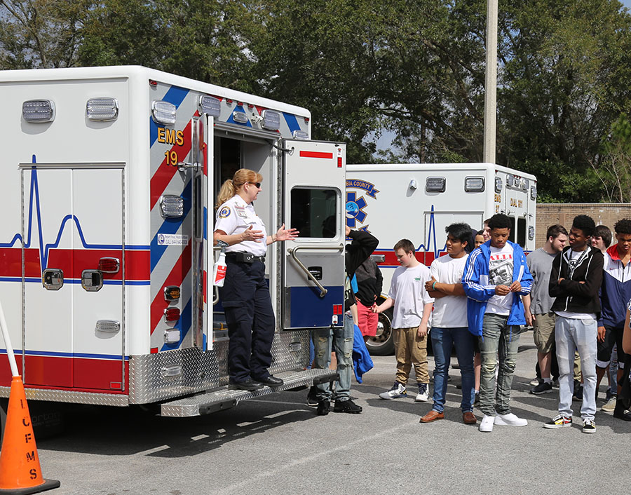 EMS staff member shows students an ambulance