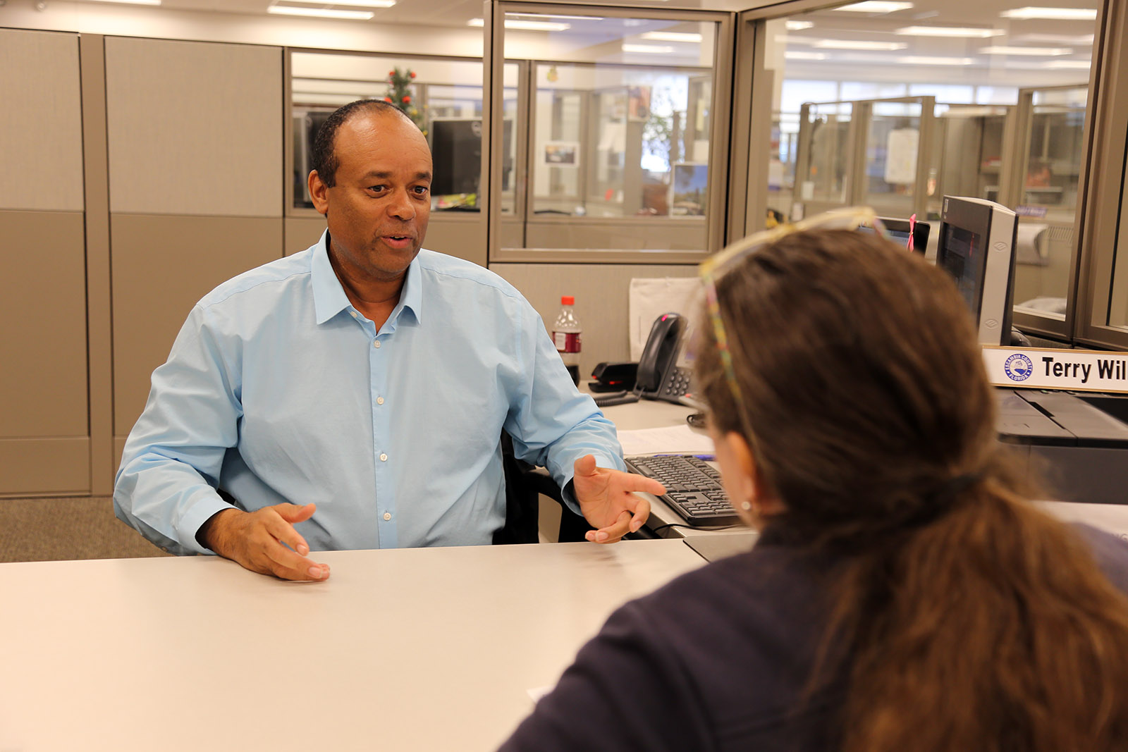 Building Services representative in the office with a customer