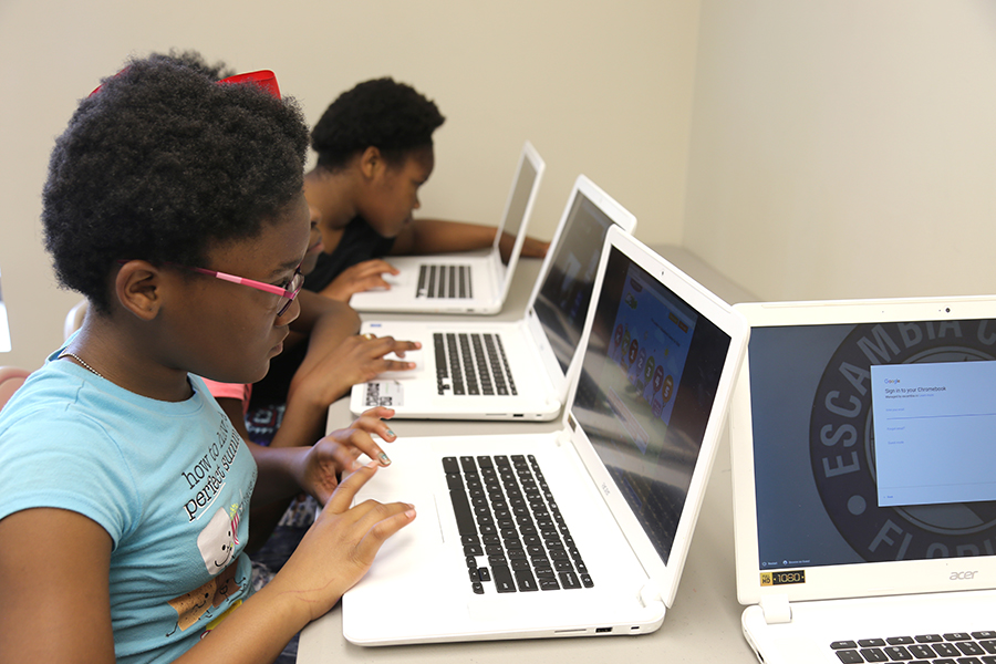 Youth use Chromebooks at one of Escambia County's community center programs