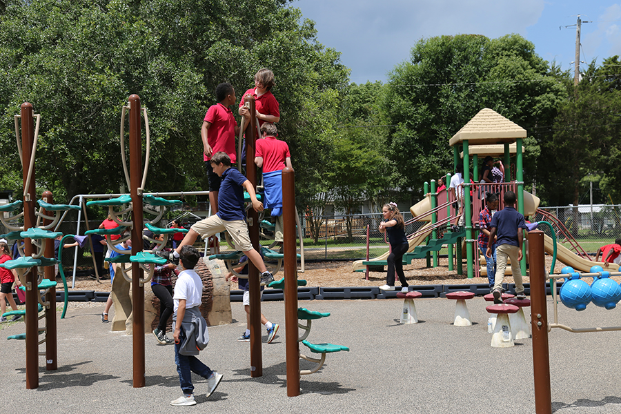 Children play on the playground at Old Ensley Park.