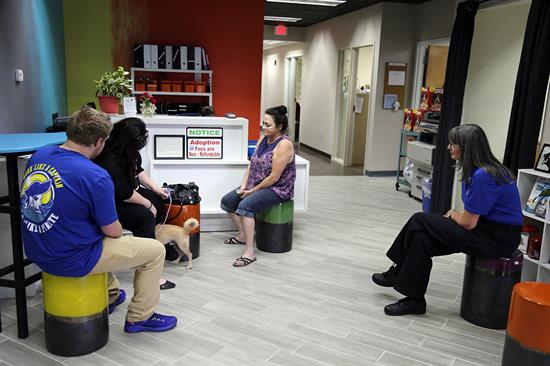 Kathy Nelson and her family finish up their adoption paperwork with shelter staff inside the lobby. Kathy Nelson and her family finish up their adoption paperwork with shelter staff inside the lobby.