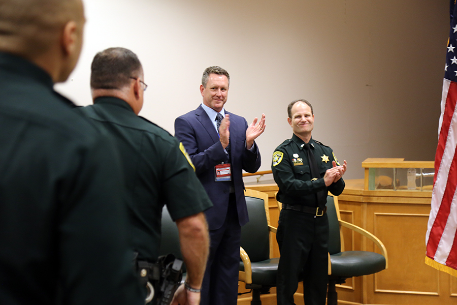 Assistant County Administrator Matt Coughlin and 1st Lt. Jason Walker congratulate award recipients at the Corrections Staff Awards Ceremony on Aug. 22.