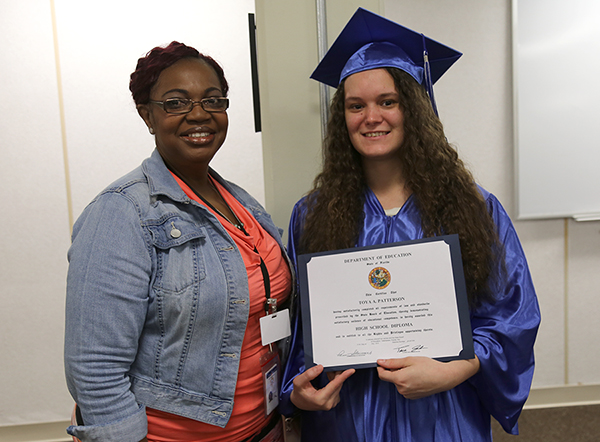 Rayshell Fairley Toya Patterson Instructor Rayshell Fairley recognizes Toya Patterson with her diploma at a GED graduation ceremony at the Escambia County Jail.