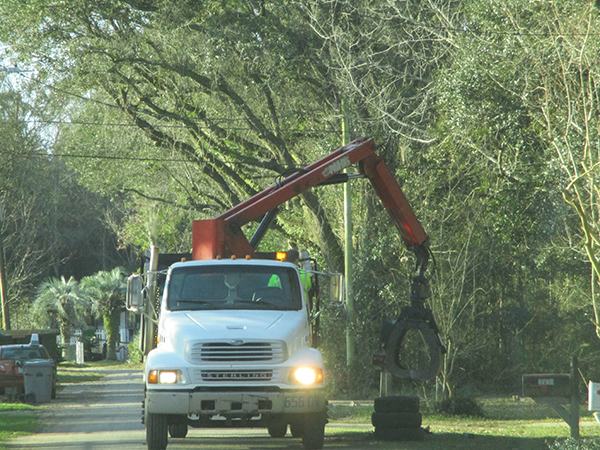 A truck picks up tires during the Ensley South Neighborhood Cleanup