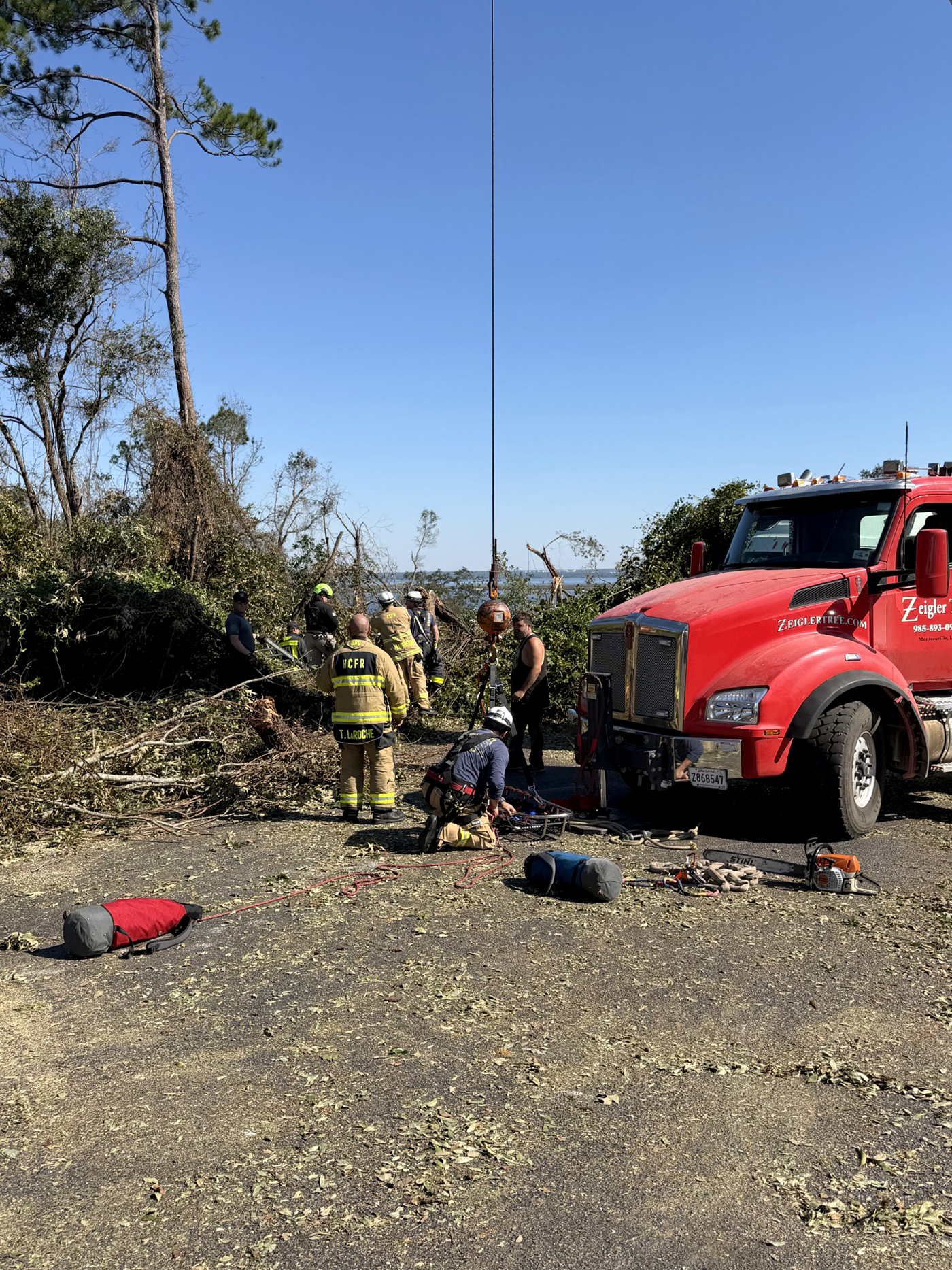 First responders rescue someone on an embankment 