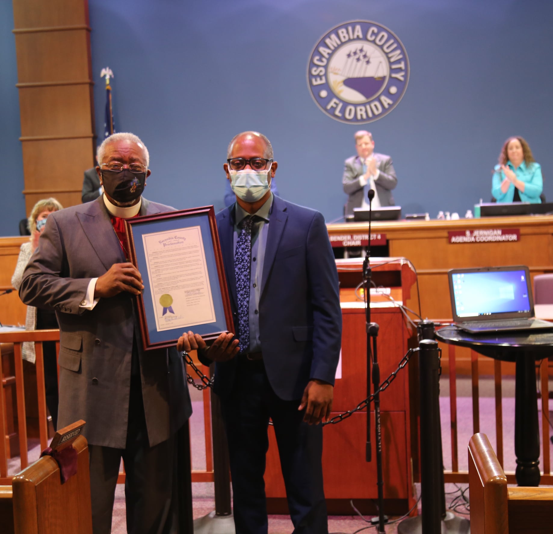 District 3 Commissioner Lumon May presents Rev. John Powell with a proclamation in recognition of a lifetime of service.