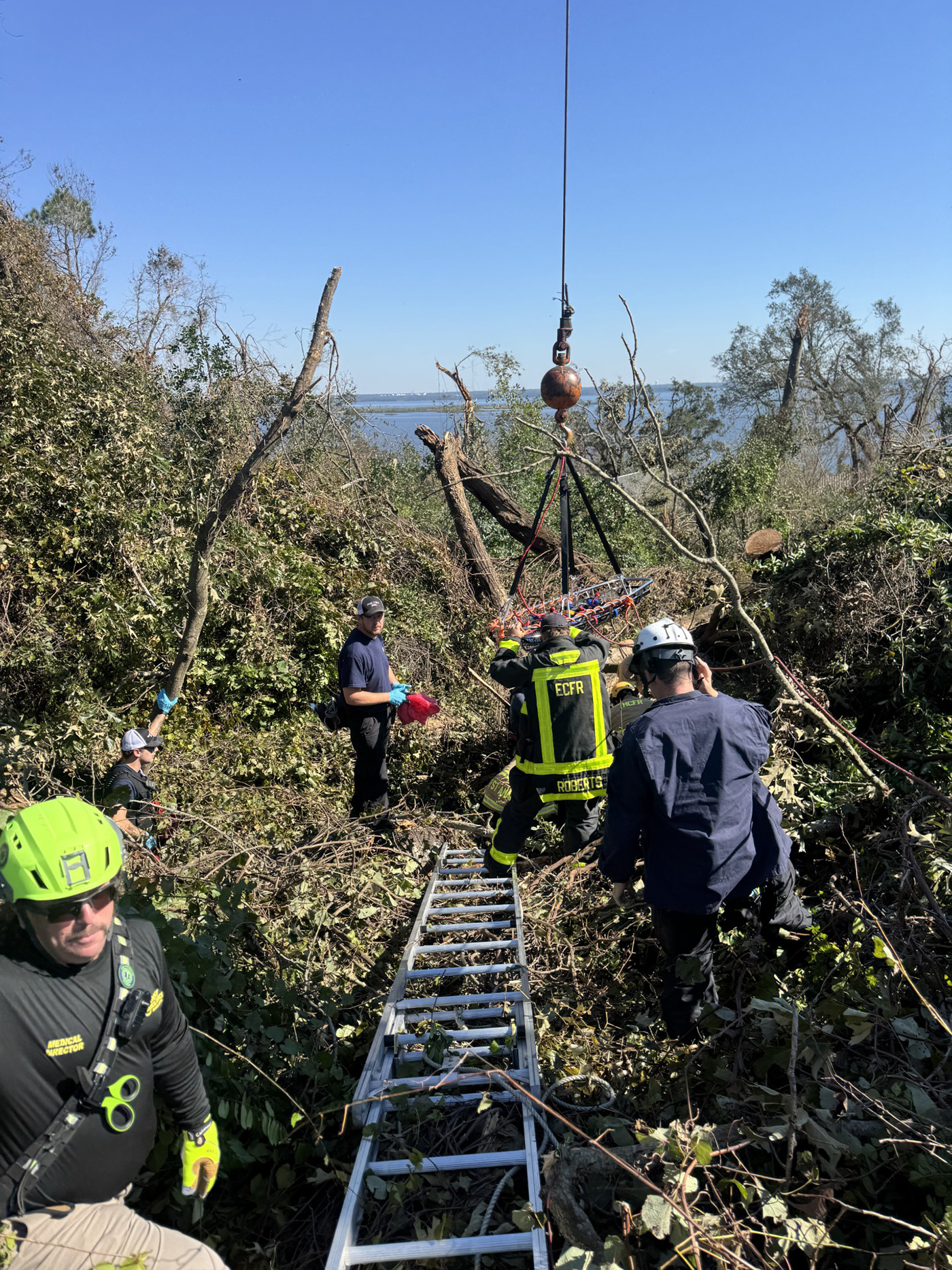 First responders rescue someone on an embankment 