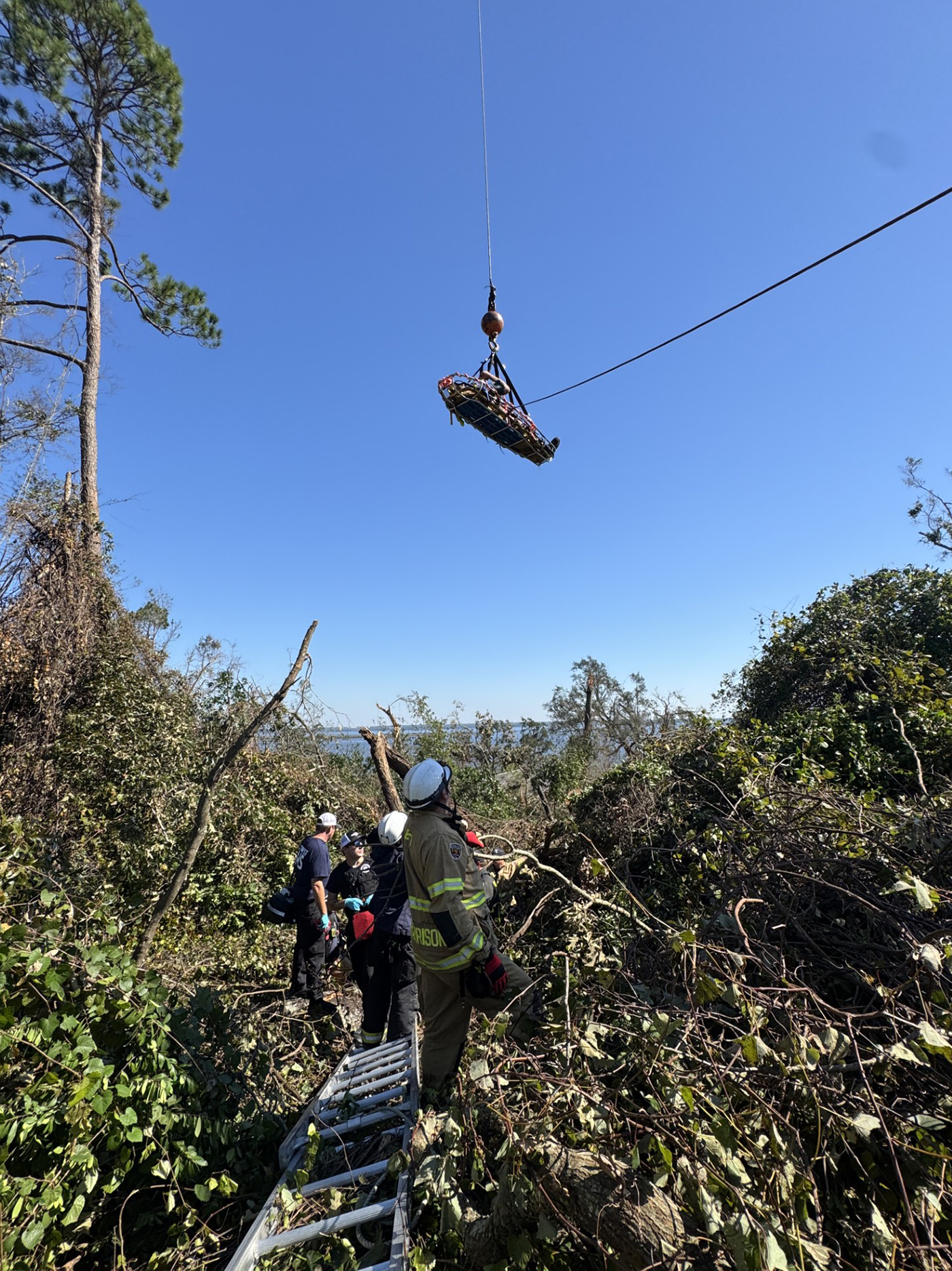 First responders rescue someone on an embankment 