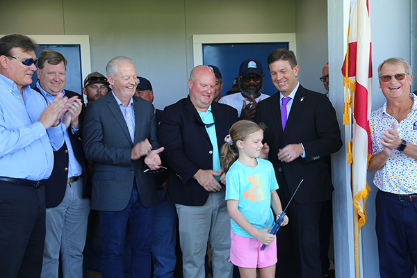 District 5 Commissioner Steven Barry and others celebrate the ribbon cutting of a new facility at Ashton Brosnaham Athletic Park.