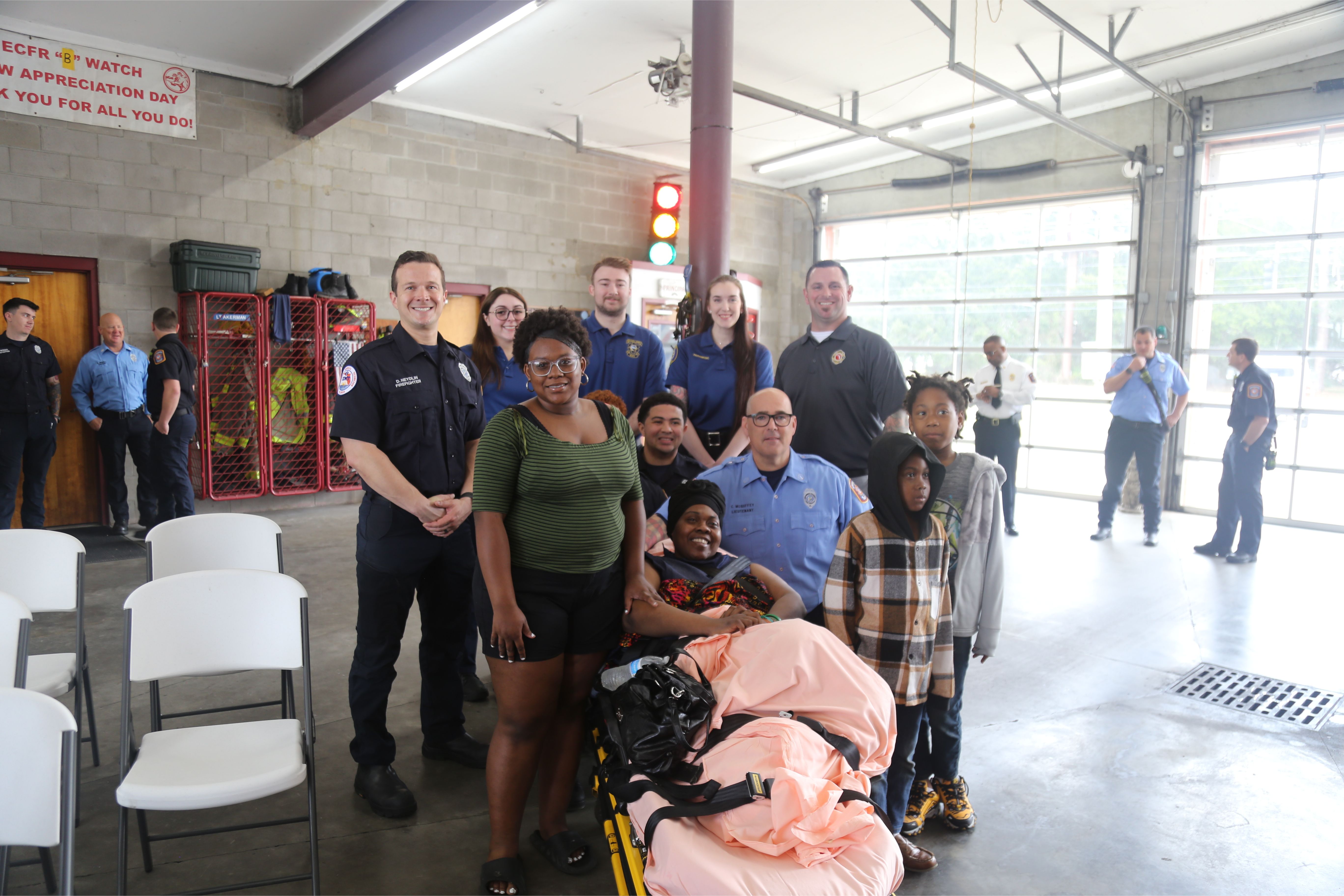Firefighters, paramedics and EMTs from the Deauville fire with the rescued victim and her family