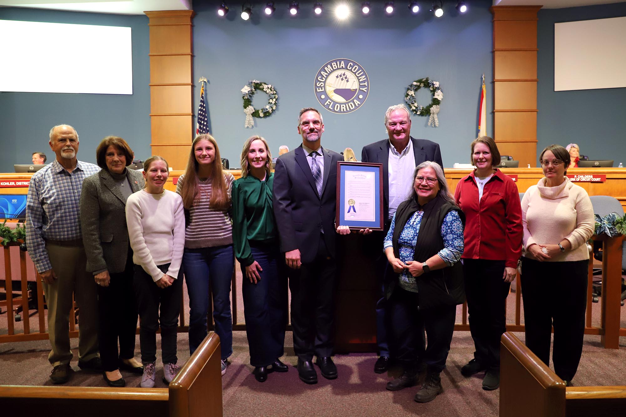 Group of people posing for a photo during an award acceptance