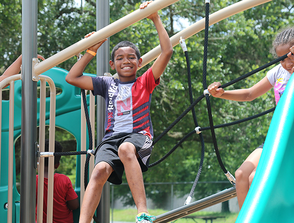 Children in the Play, Learn, Grow Summer Camp Program enjoy the new playground at Ebonwood Community Center.