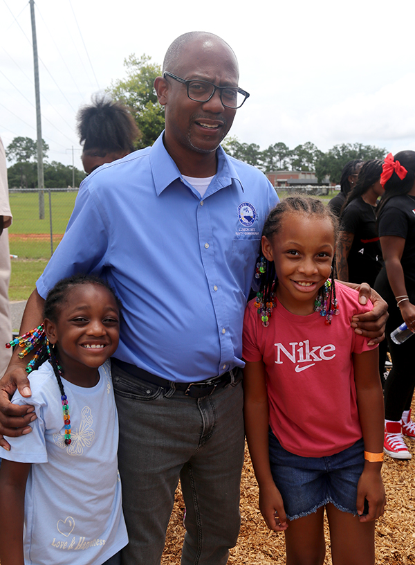 Commissioner May with two students