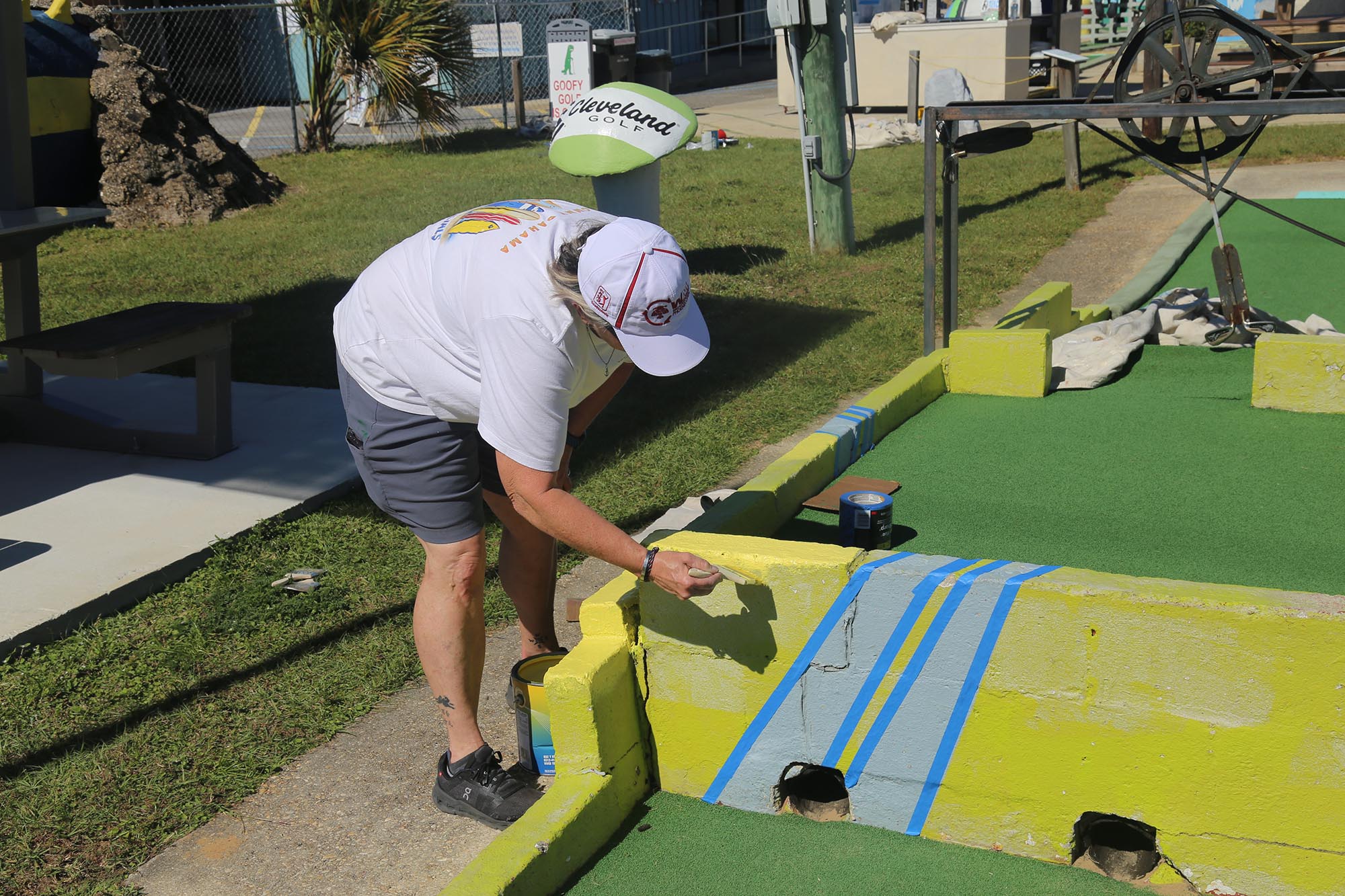 Engineering at Day of Caring Woman painting a golf course