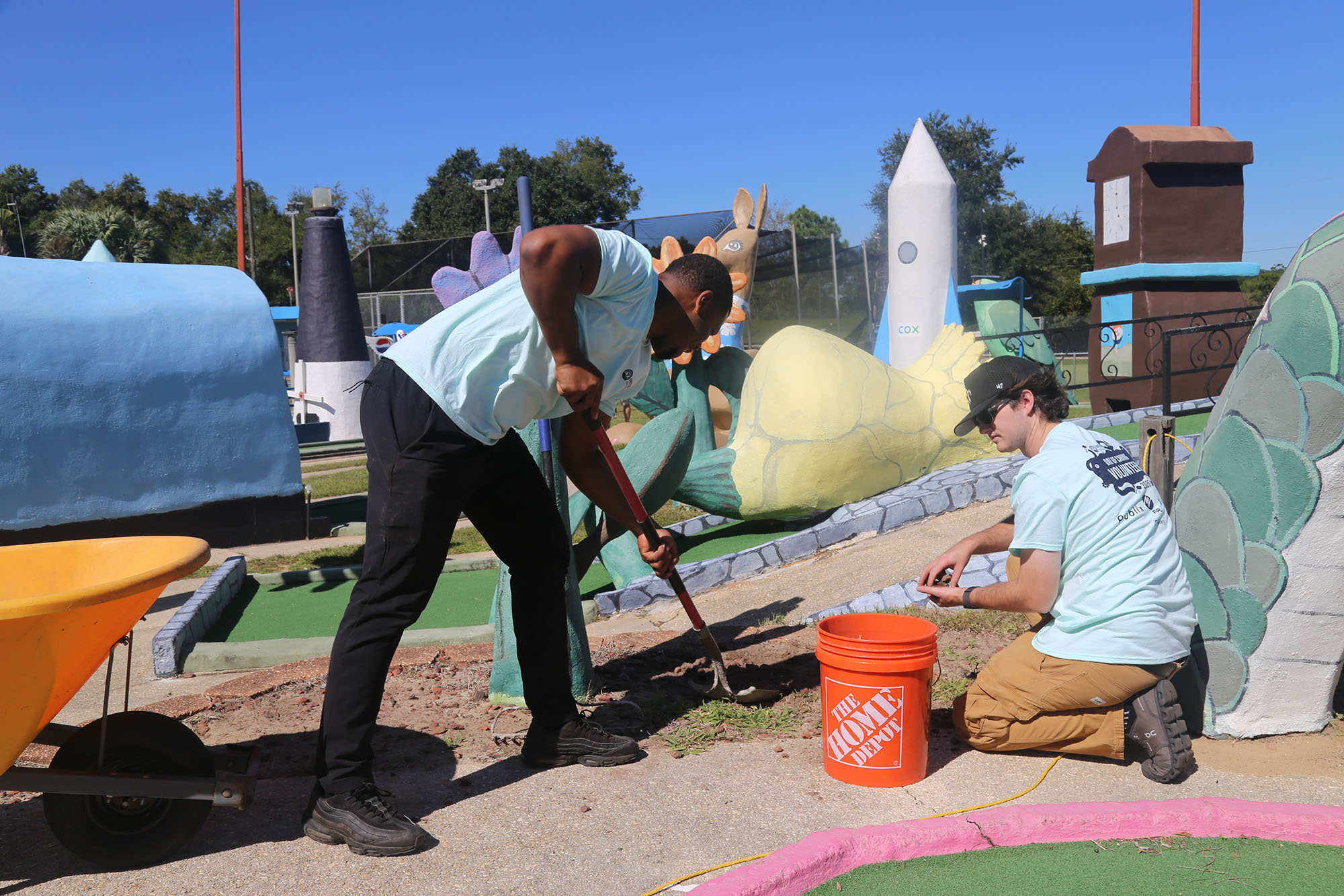 Engineering at Day of Caring Men doing landscaping work
