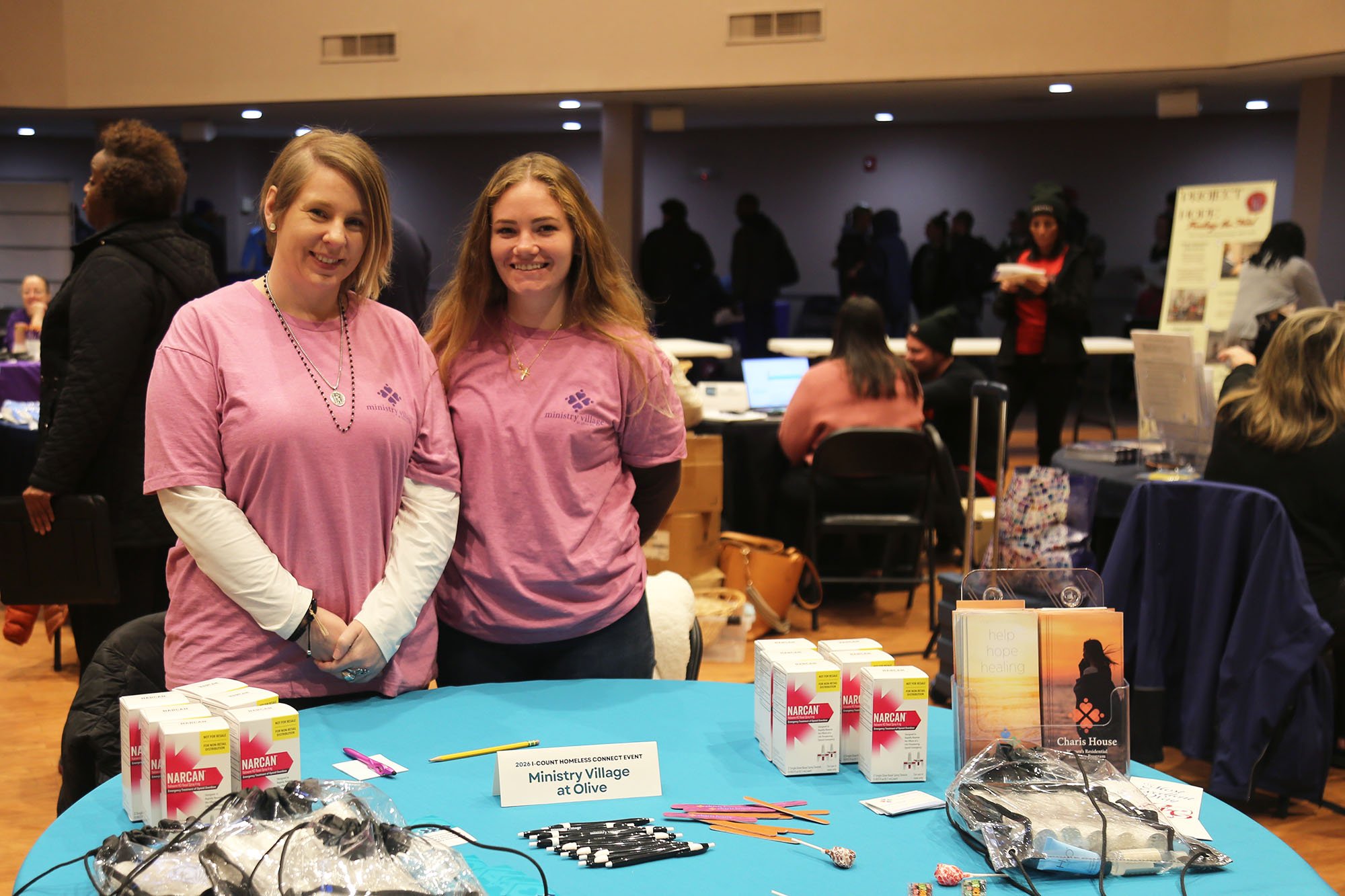 Two women at a vendor table
