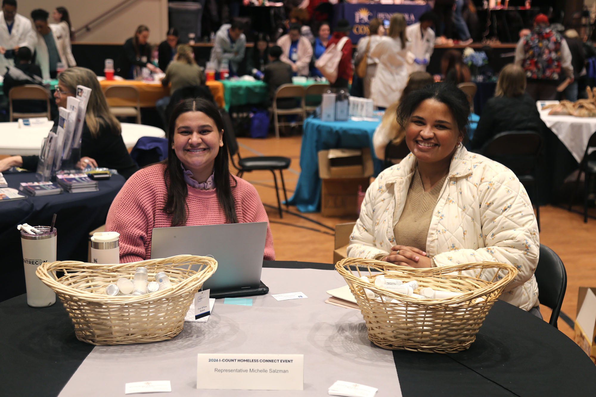 Girls smiling at a vendor table