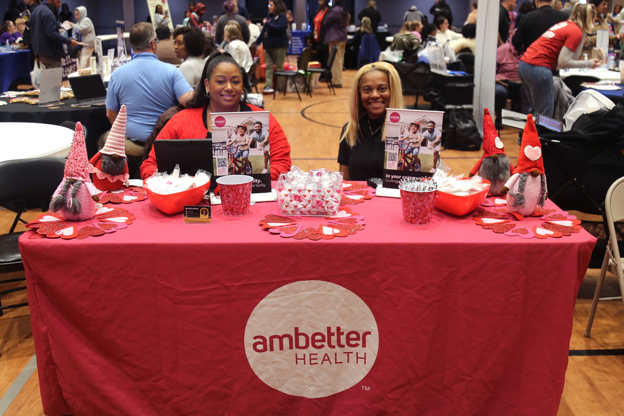 Women smiling at a vendor table