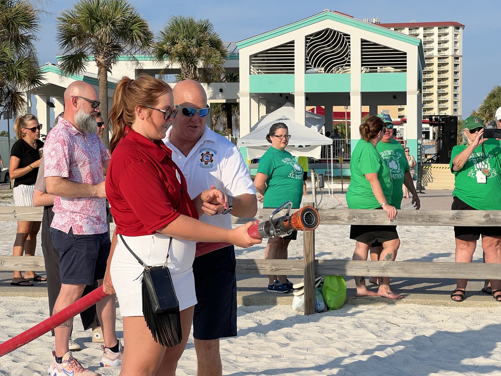 Captain Scott Averill teaching a volunteer how to use the fire hose