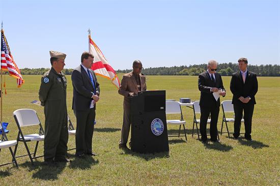 NOLF Site 8 Ceremony Speakers on Field at Podium NOLF Site 8 Ceremony Speakers on Field at Podium