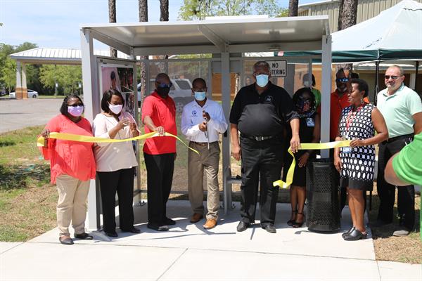 Bus shelter and sidewalk ribbon cutting in D3 Bus shelter and sidewalk ribbon cutting in D3