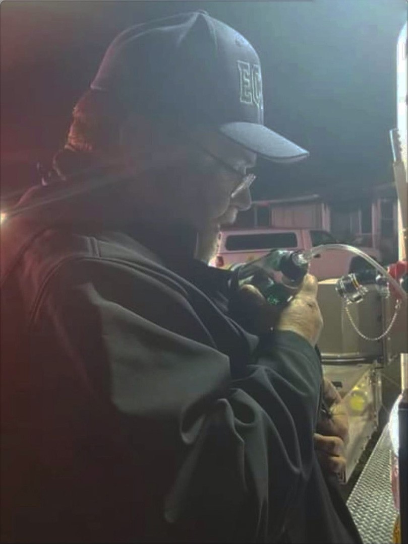 ECFR Fire and Life Safety Specialist Ray Melton provides dog with oxygen following recue at a fire on the 6700 block of W. Jackson St.