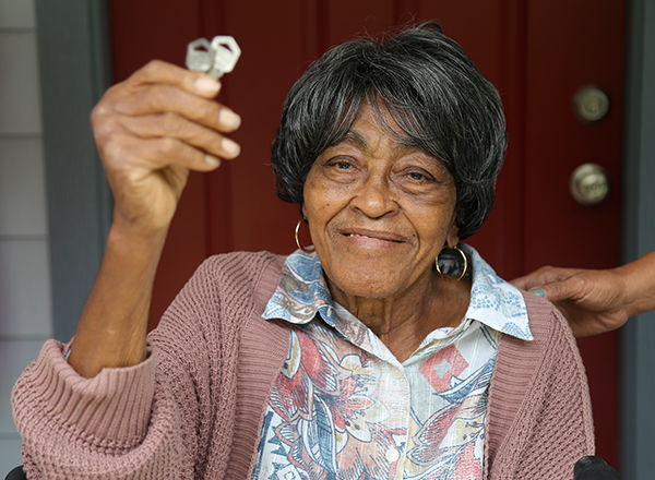 A resident celebrates her new home