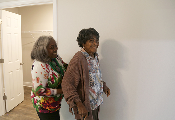 A resident tours her new home