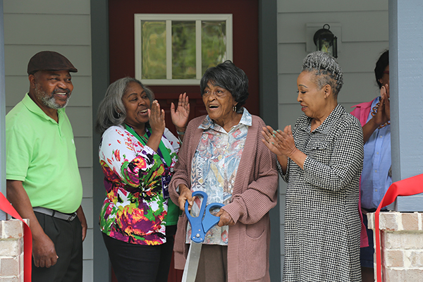 A resident celebrates her new home