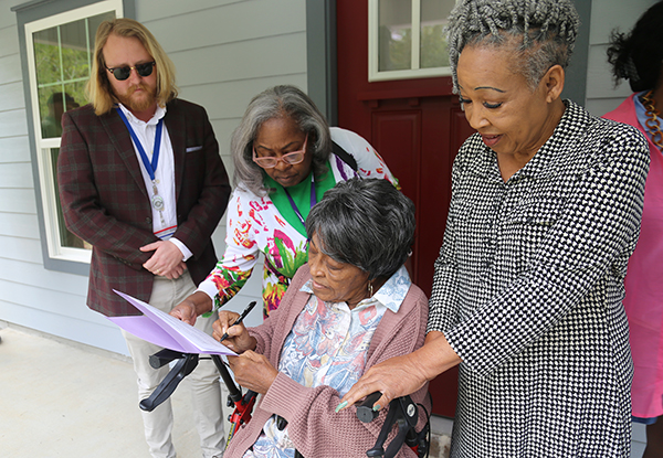 A resident celebrates her new home