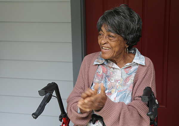 A resident celebrates her new home