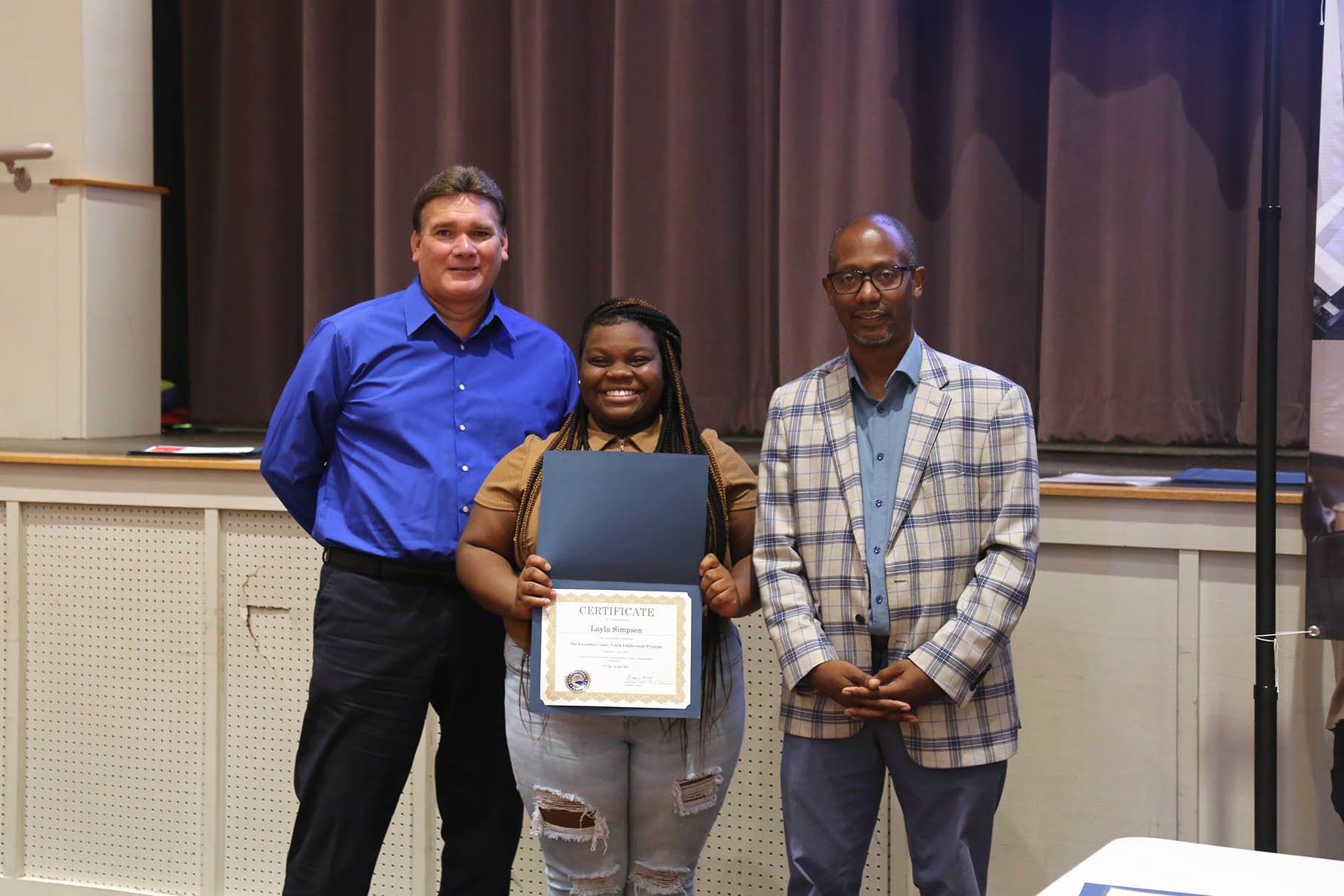 Interim County Administrator Wes Moreno, Summer Youth Employee Layla Simpson, and D3 Commissioner Lumon May, 