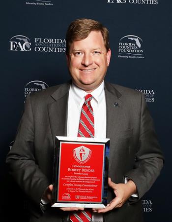 Commissioner Bender at FAC Graduation Commissioner Bender holding the CCC graduate plaque