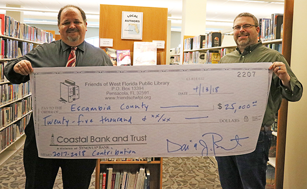 Friends library donation Library Director Todd Humble and Friends of West Florida Public Library President Michael Lane.