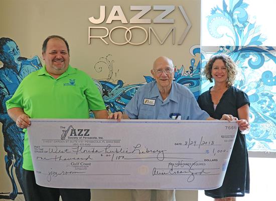 Jazz Pensacola donated $1,000 to West Florida Public Libraries for expenses of new materials for the Jazz Room such as jazz books, CDs, and DVDs. Jazz Pensacola donated $1,000 to West Florida Public Libraries for expenses of new materials for the Jazz Room such as jazz books, CDs, and DVDs.