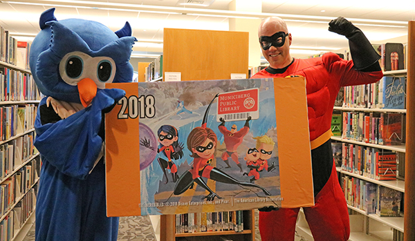 Whooo the Owl and Mr. Incredible pose with a large version of the special edition library cards West Florida Public Libraries is offering during September in honor of National Library Card Sign-up Month
