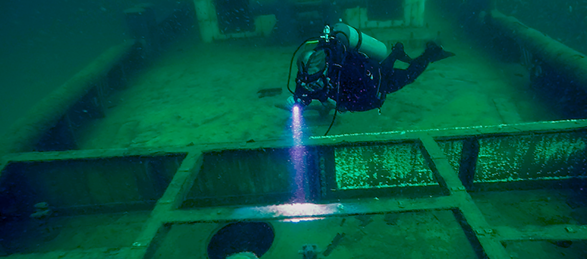 A scuba diver examines the Ocean Wind