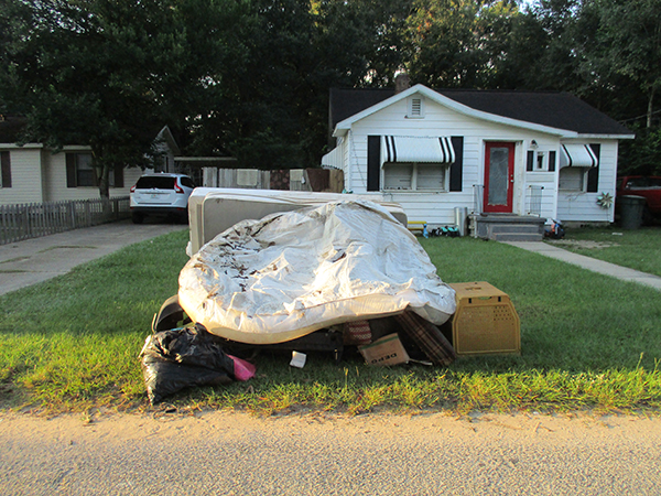 Photo of items left at the curb in front of a home during the Brownsville Northwest Neighborhood Cleanup.