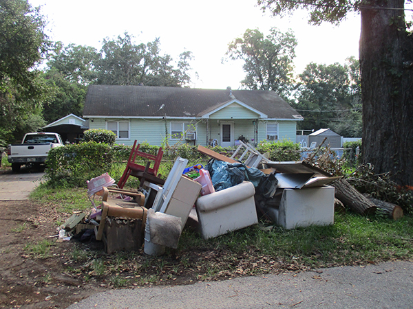 Photo of items left at the curb in front of a home during the Brownsville Northwest Neighborhood Cleanup.