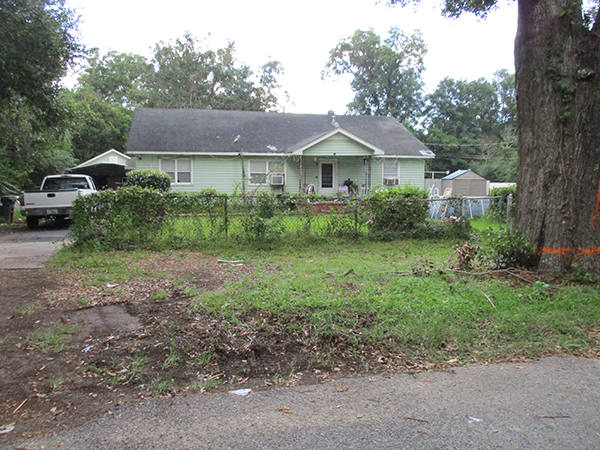 Photo of a clean curbside in front of a home after items were picked up during the Brownsville Northwest Neighborhood Cleanup.