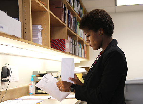 Youth employee Raina Brown prepares bills to be mailed at Escambia County's Public Safety building on W Street. 