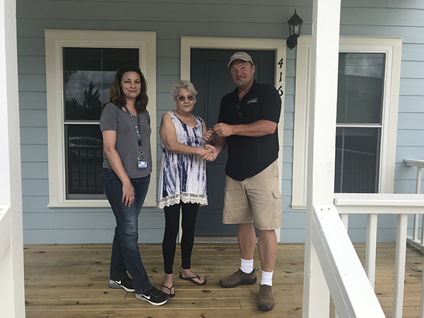 Residents receive keys to their new home in Century, funded through the SHIP program to replace their home that was damaged by the February 2016 tornado.