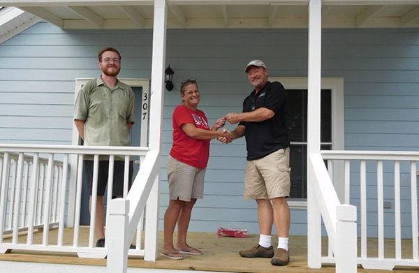 Residents receive keys to their new home in Century, funded through the SHIP program to replace their home that was damaged by the February 2016 tornado.