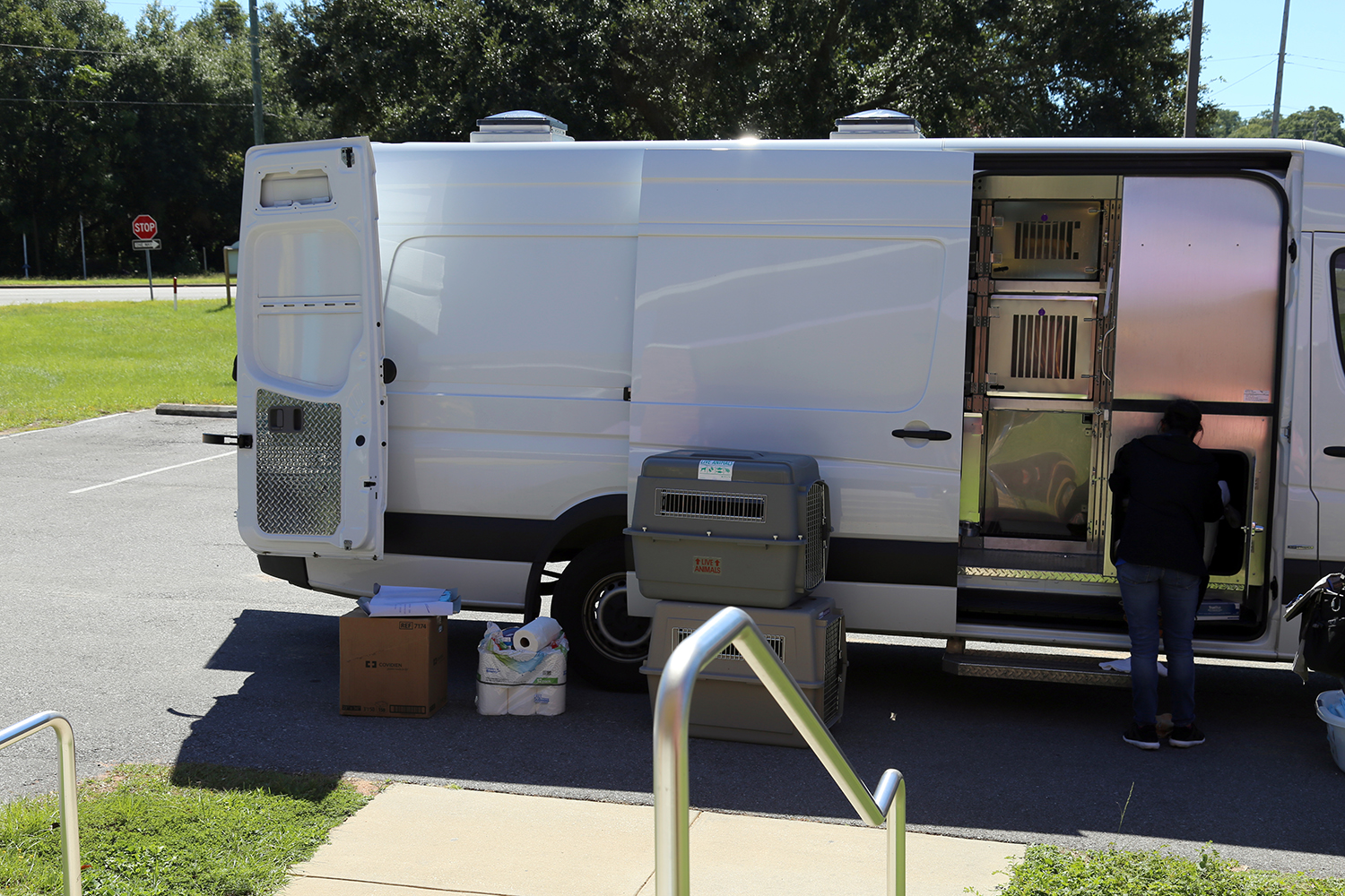 Animal Shelter staff prepares to load dogs on transport van headed for Michigan Humane Society.