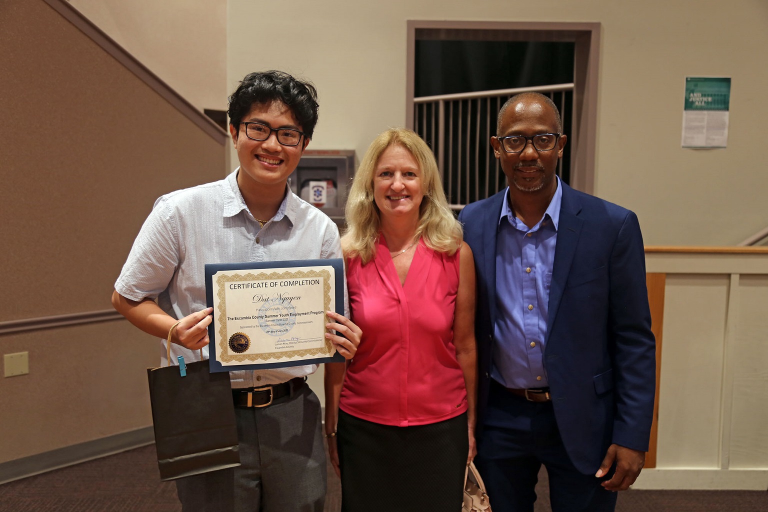 Commissioner May, County Attorney Alison Rogers, and Summer Youth Employee Dan Nguyen